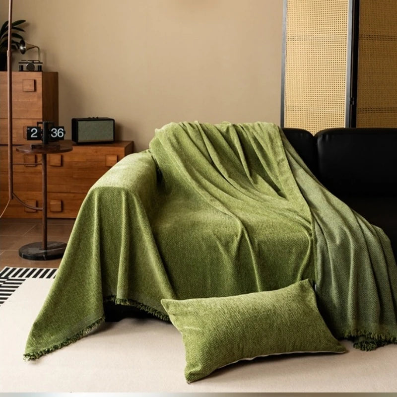 Draped sofa cover thrown over a sofa in green